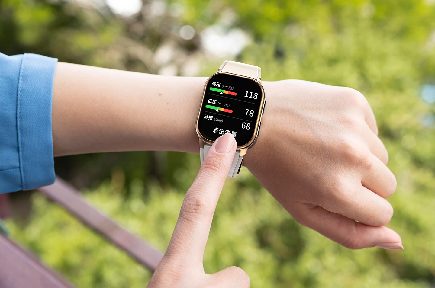 Person using a wrist-worn blood pressure watch during an outdoor routine