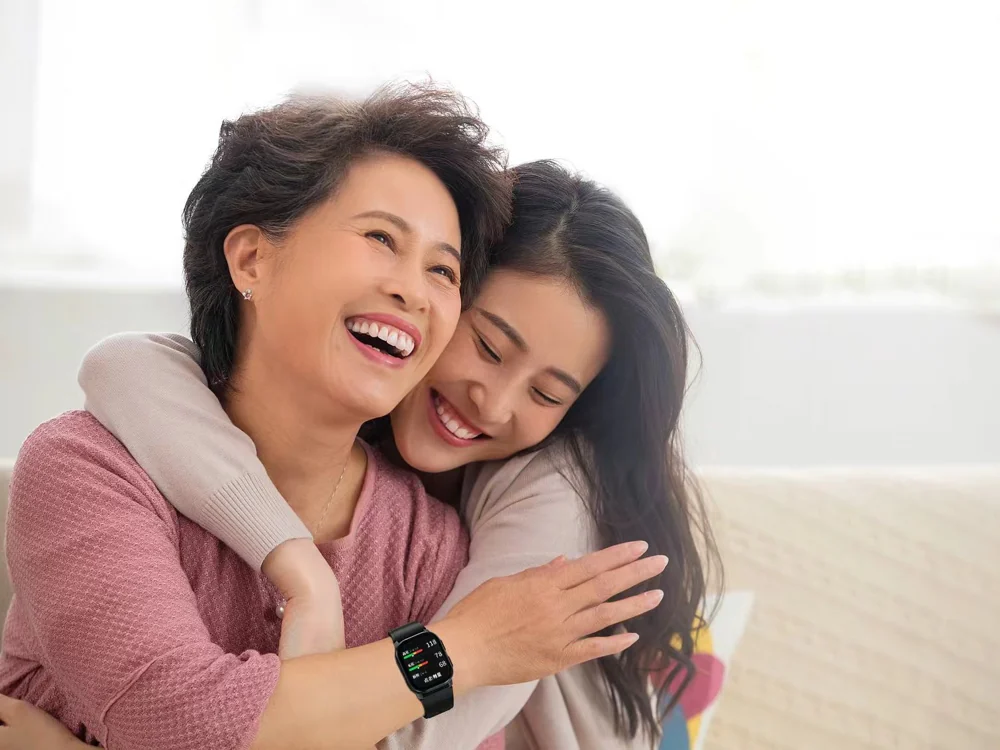 Older woman and family member together with a connected health watch
